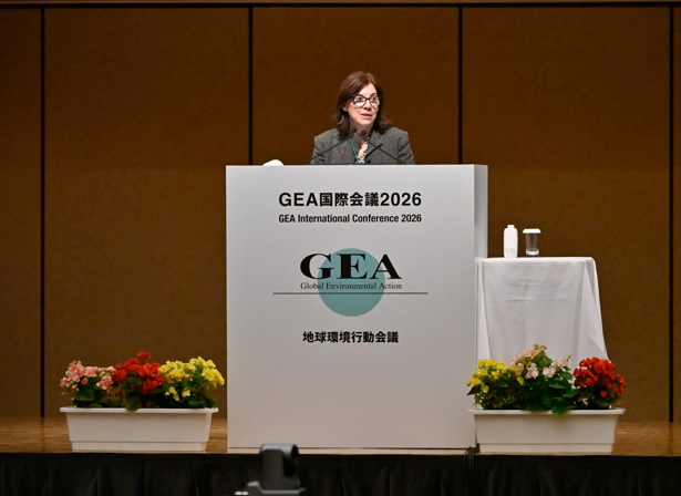 Dr. Pam McElwee professor standing behind a lecturn in Tokyo Japan